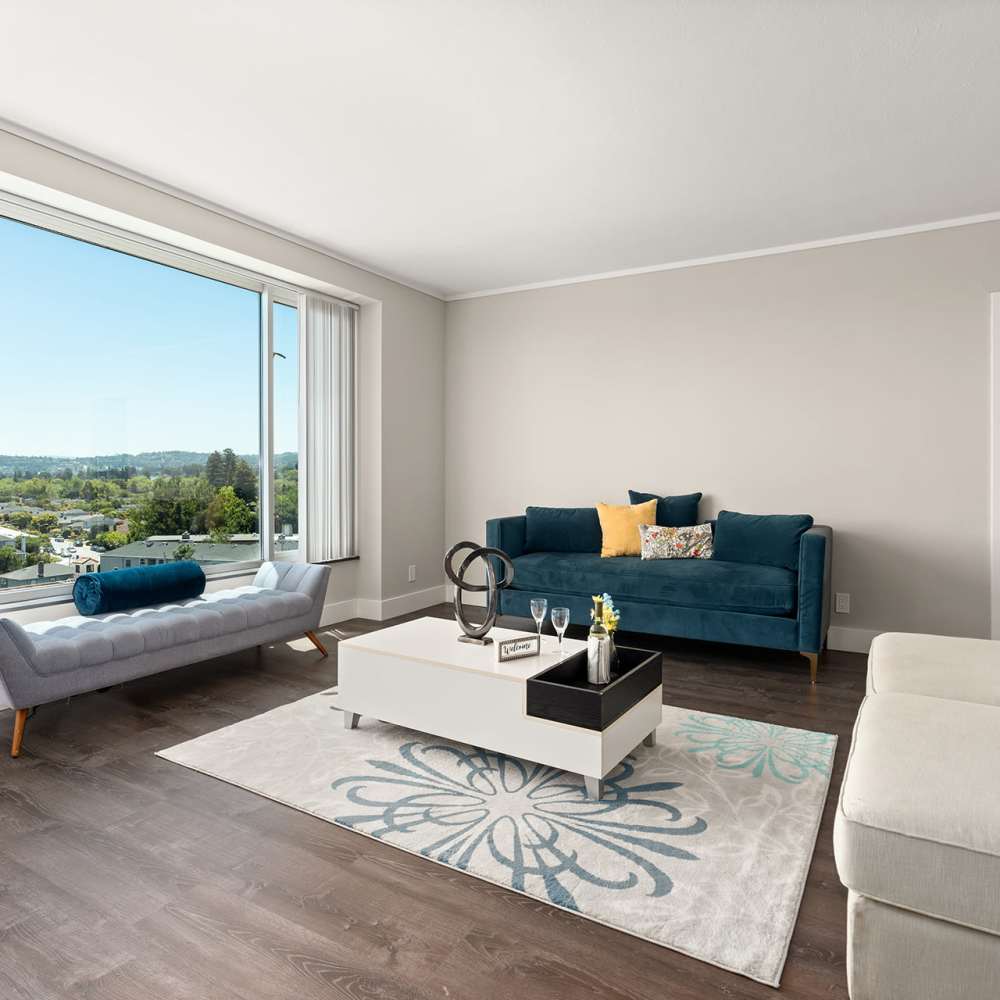 Beautiful living area with blue couch at Ryan Tower San Mateo, California