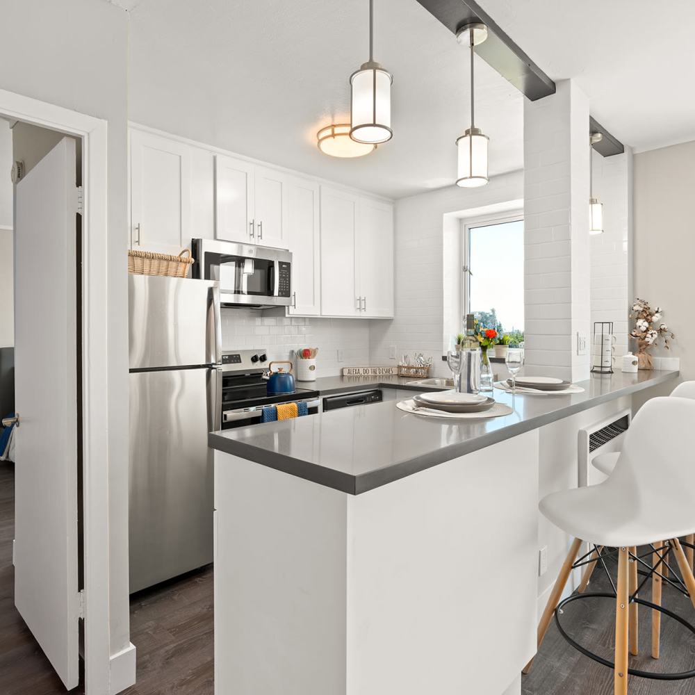 Stainless steel kitchen with light fixtures and window at Ryan Tower San Mateo, California