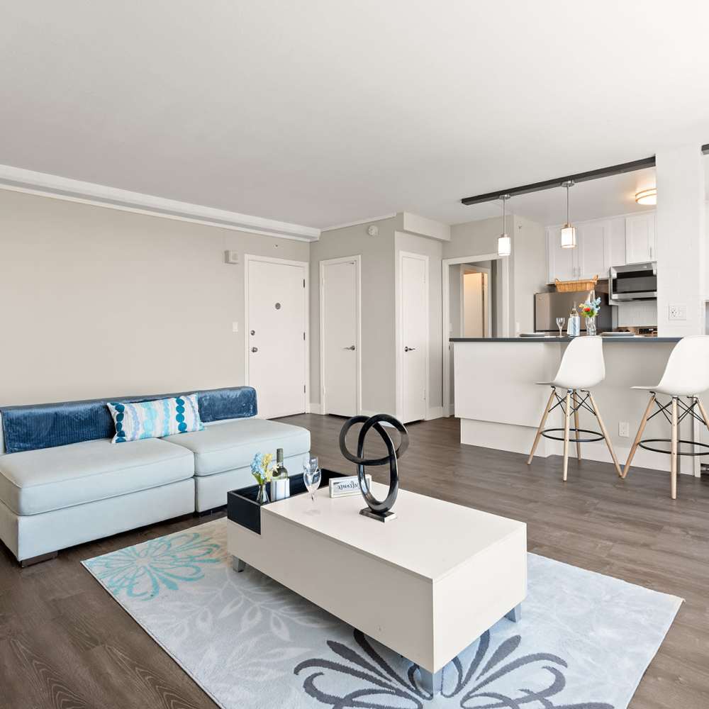 Spacious living area with bar stools at Ryan Tower San Mateo, California