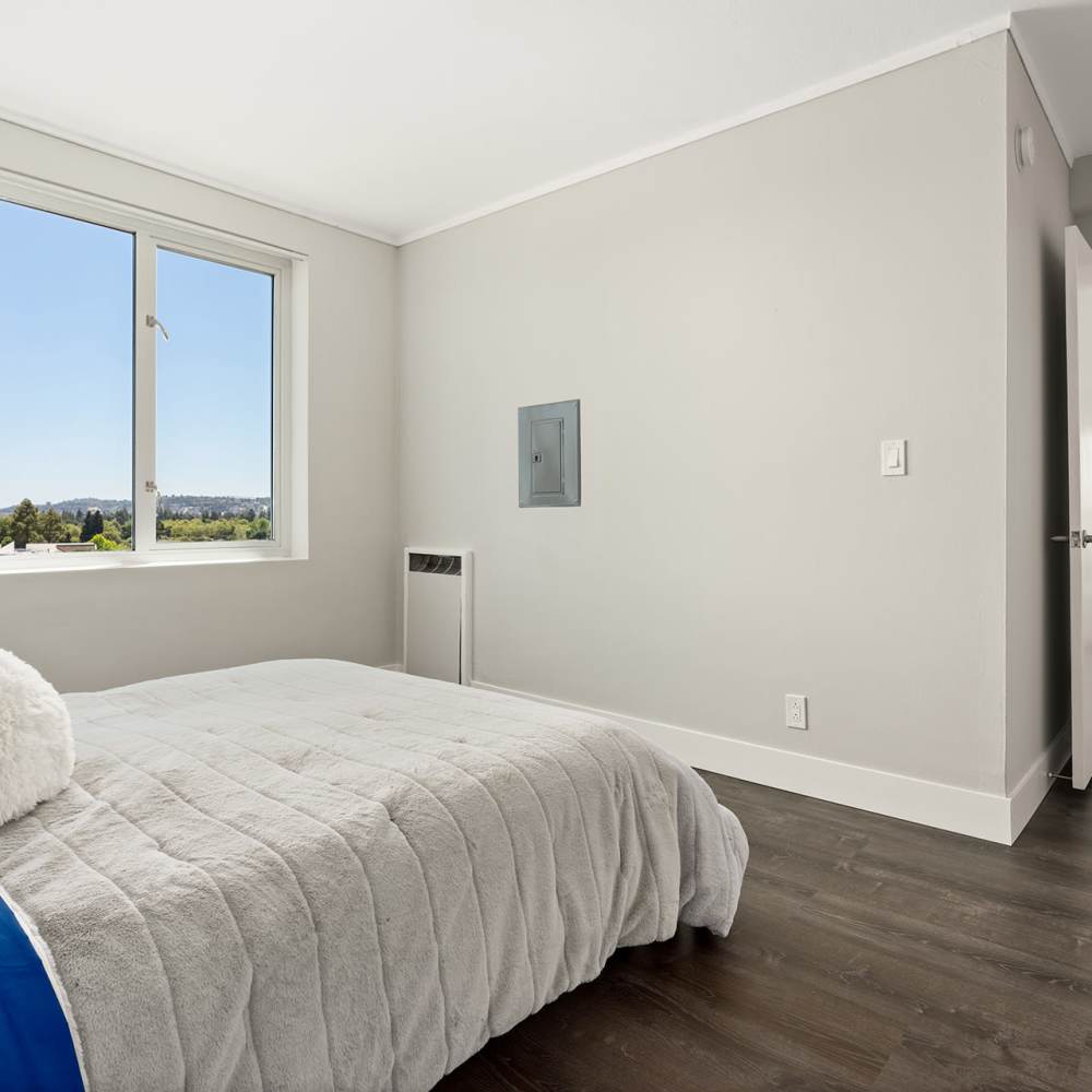 Rear view of a large bedroom with window at Ryan Tower San Mateo, California