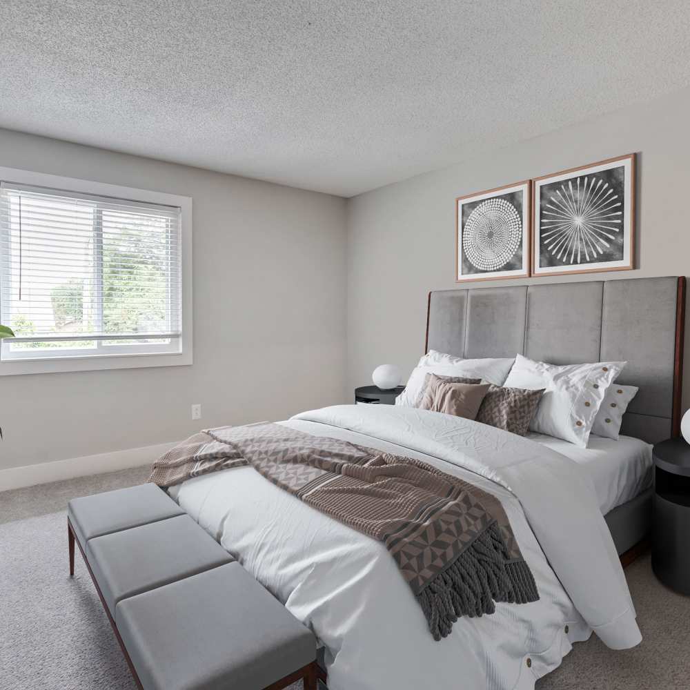 Pleasing bedroom with a large bed, wall décor and a window with blinds at Nottingham Apartments in Hendersonville, Tennessee