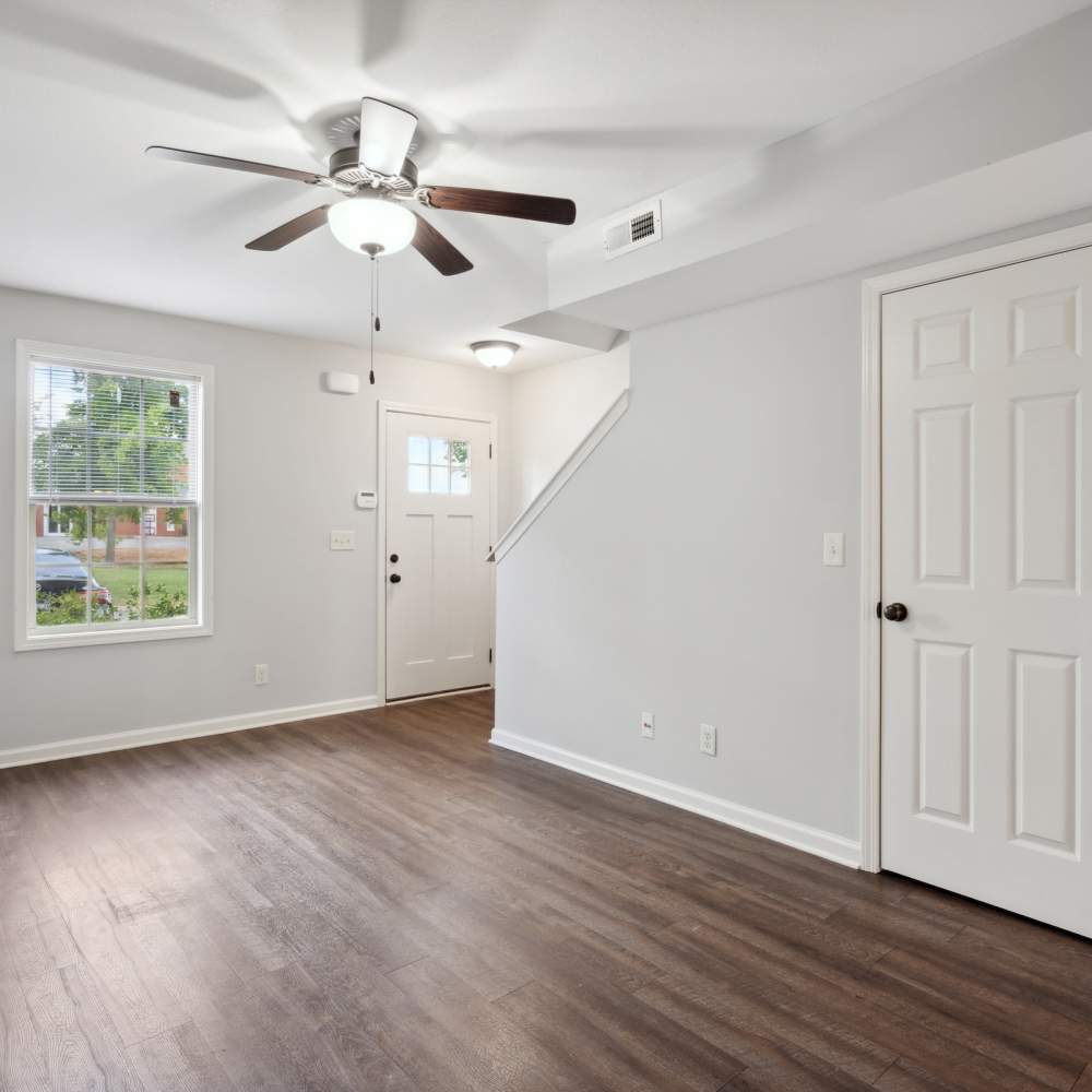 Spacious and bright living room with wood-style flooring at Northpark Commons in Clarksville, Tennessee