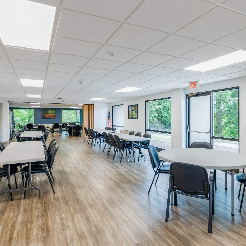 Community room with tables at Perrytown Place in Pittsburgh, Pennsylvania