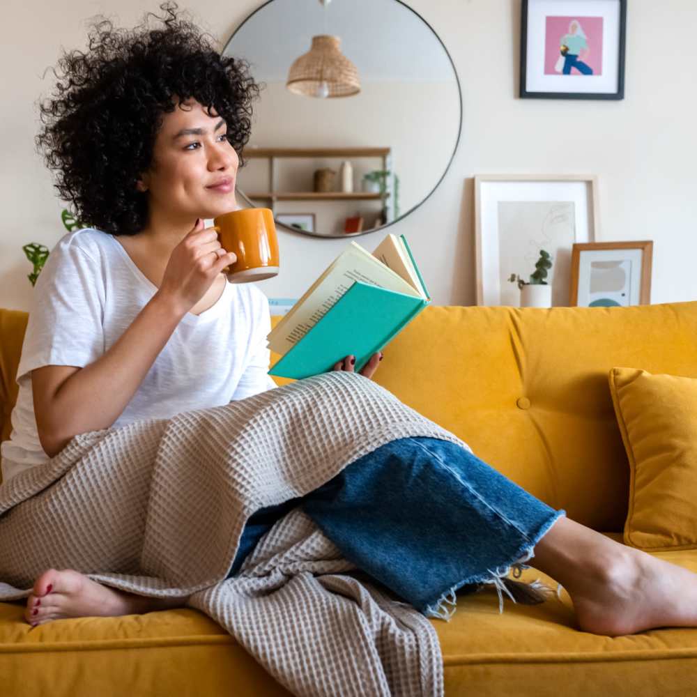 Resident sitting on the couch in her living room at Haggerty Lane in Bozeman, Montana