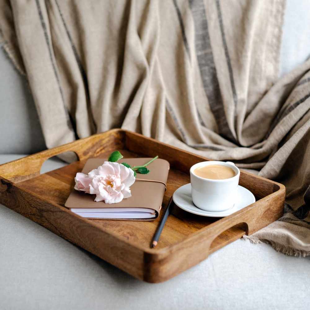 Tray with coffee and a journal on a couch at Haggerty Lane in Bozeman, Montana