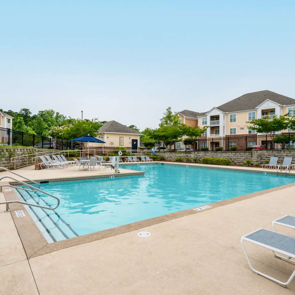 Relaxing pool area with lounge chairs at The Reserve at White Oak in Garner, North Carolina