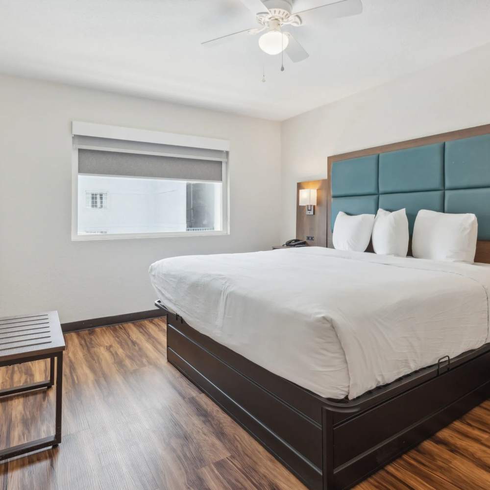 Spacious bedroom with wood-style flooring at Atrium Flats in Nashville, Tennessee