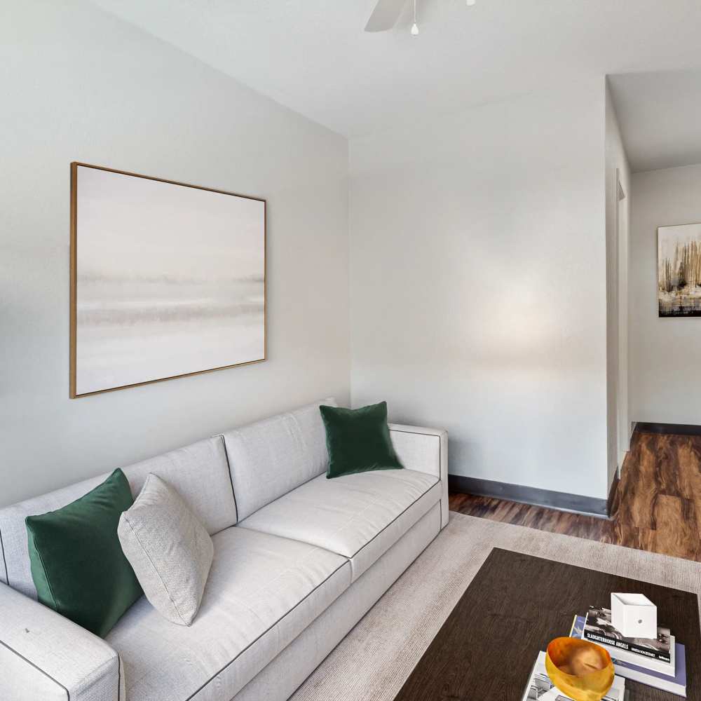 White couch in a living room with wood-style flooring at Atrium Flats in Nashville, Tennessee