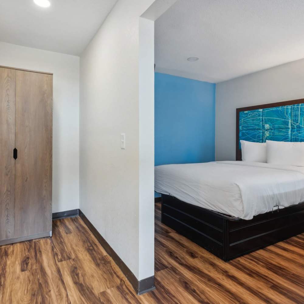 Bedroom with a blue accent wall at Atrium Flats in Nashville, Tennessee