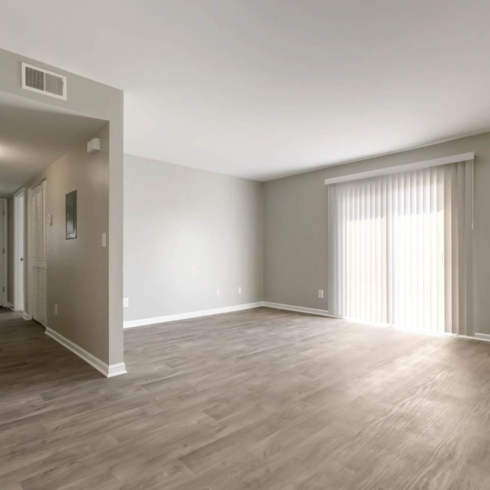 Apartment living room with a sliding door out to a private patio at The Flats At Wilkinson in White House, Tennessee