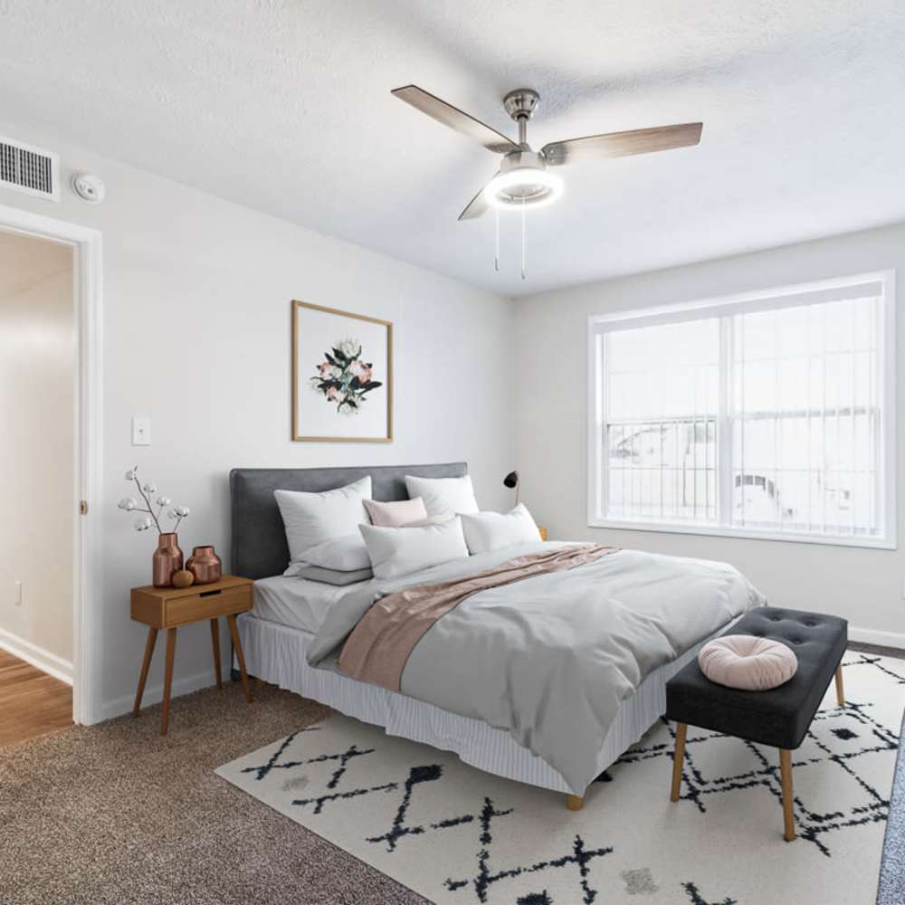 Spacious bedroom with a comfortable bed, ceiling fan and a large window at The Reserve At Lebanon in Lebanon, Tennessee  