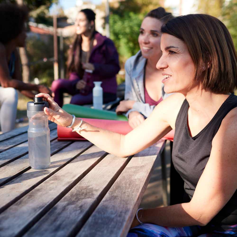 A group sitting at a picnic table at a park near The Meadowlark at Fairview in Fairview, Oregon