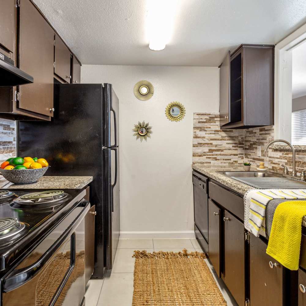 Kitchen with black appliances at Huntington Village And Cambridge Crossing in Houston, Texas