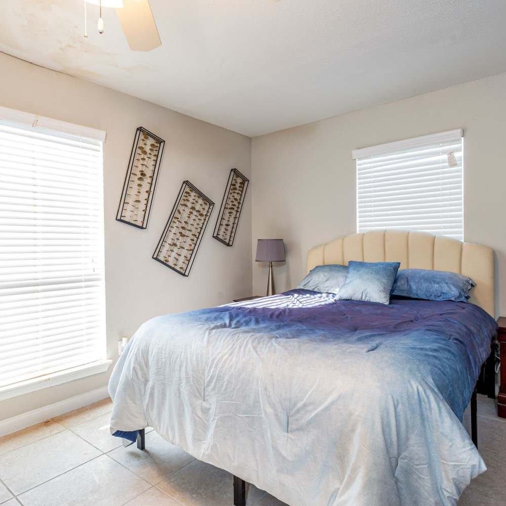 Bedroom with multiple windows at Huntington Village And Cambridge Crossing in Houston, Texas