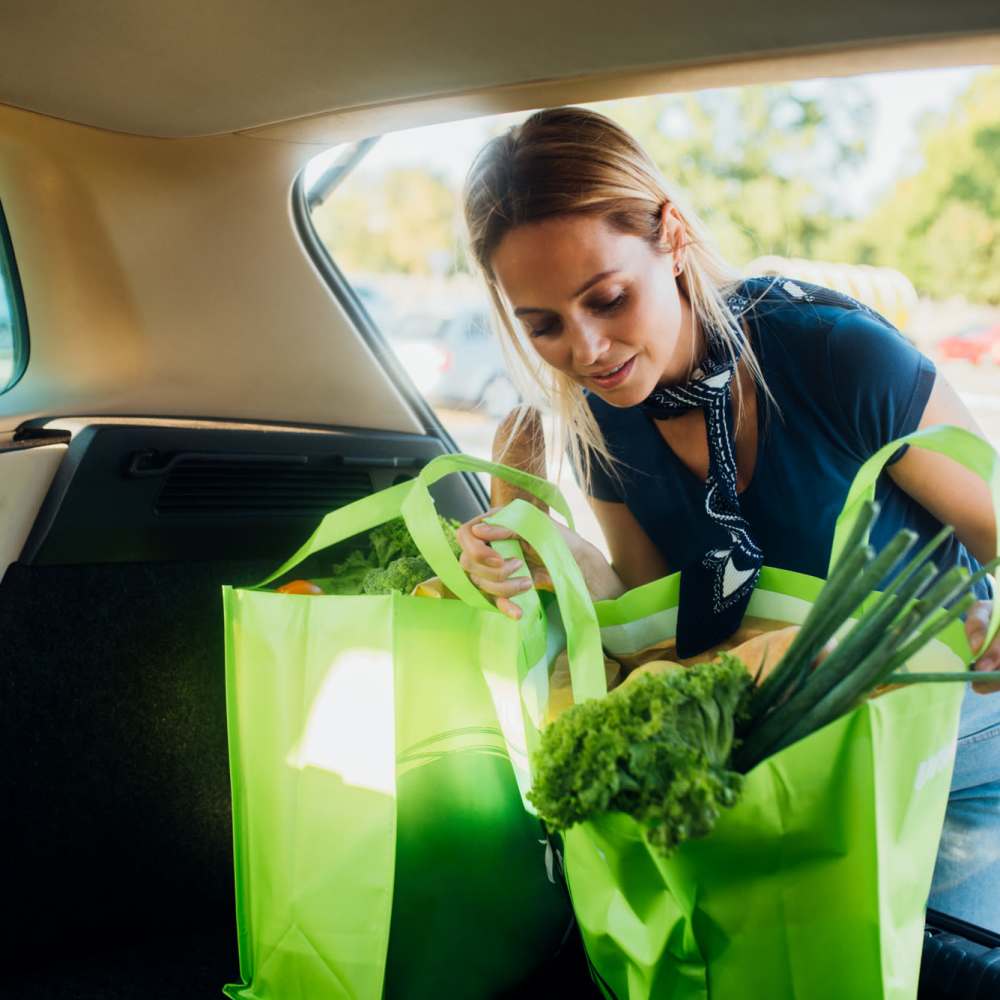 Woman loading groceries into her car near Covey Run Apartments in Forest Grove, Oregon