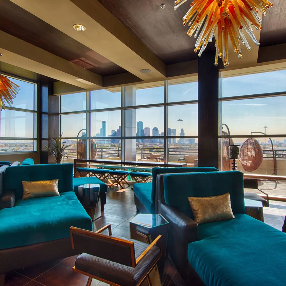 Resident seating area with large couches at Revl Heights in Houston, Texas