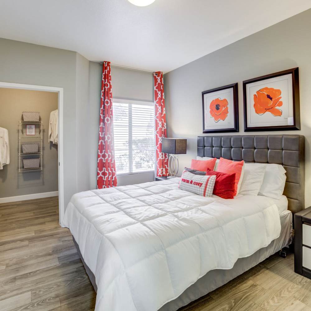 Bedroom with large windows at Calypso Apartments in Las Vegas, Nevada