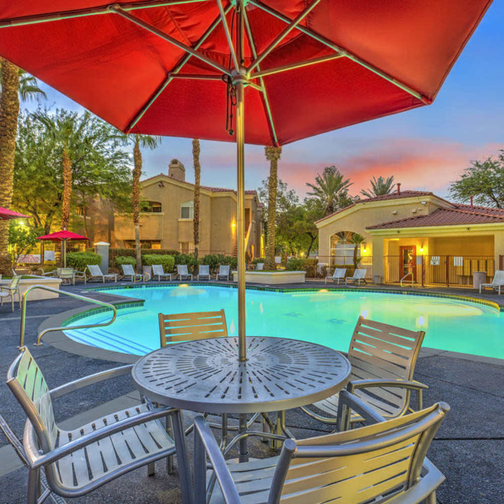 Patio tables with umbrellas at Calypso Apartments in Las Vegas, Nevada