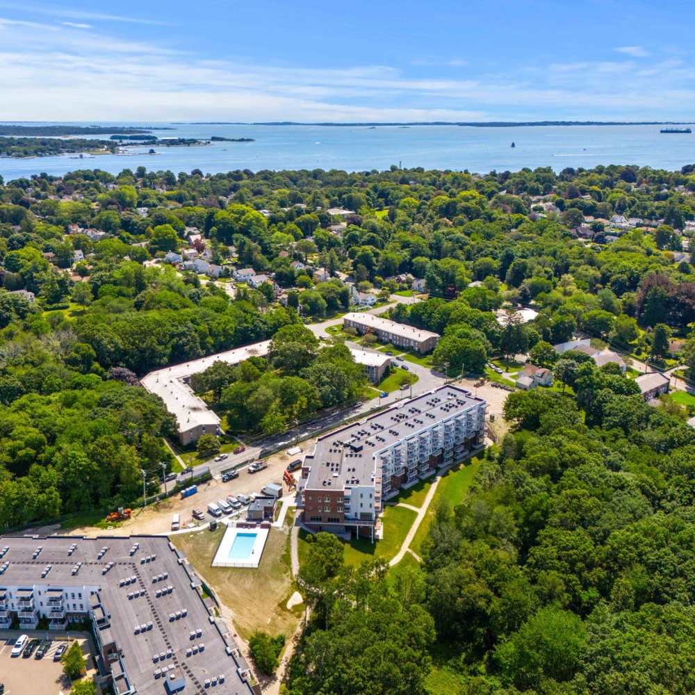 Overhead perspective of the ocean and surrounding greenery, highlighting the scenic landscape of 60 Mansfield Road in New London, Connecticut.