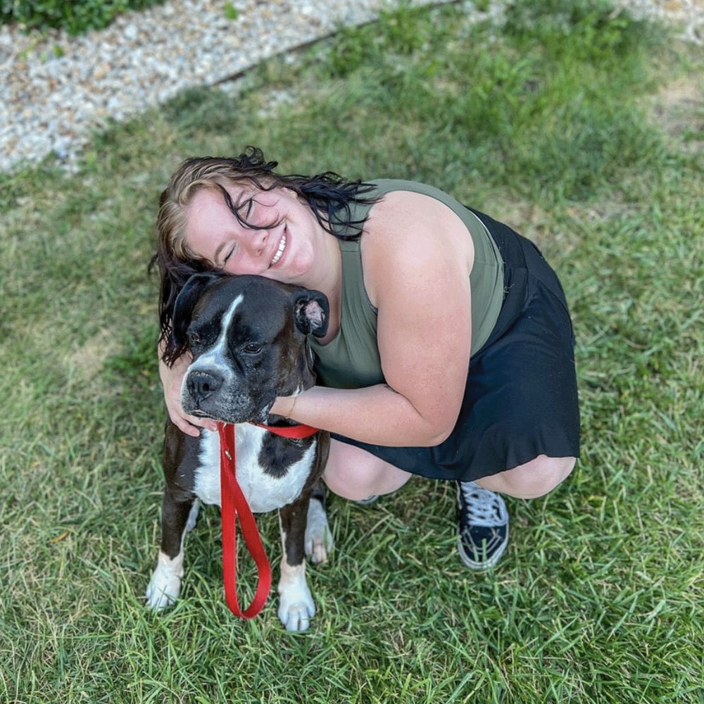 Resident hugging her dog at The Quarters Manhattan in Manhattan, Kansas