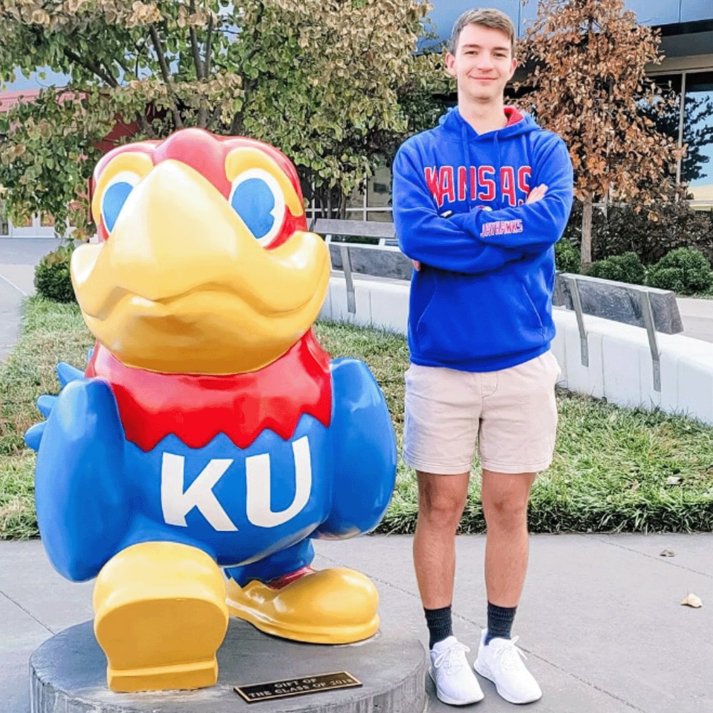 Student and Kansas University mascot near The Landing Lawrence in Lawrence, Kansas