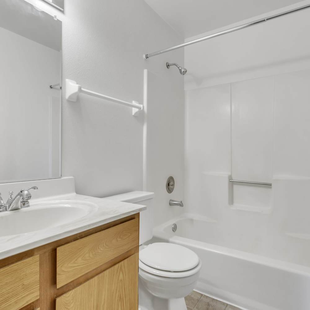 Bright bedroom with brown storage units and shiny sanitary ware at Prairie Apartments in Salem,Wisconsin