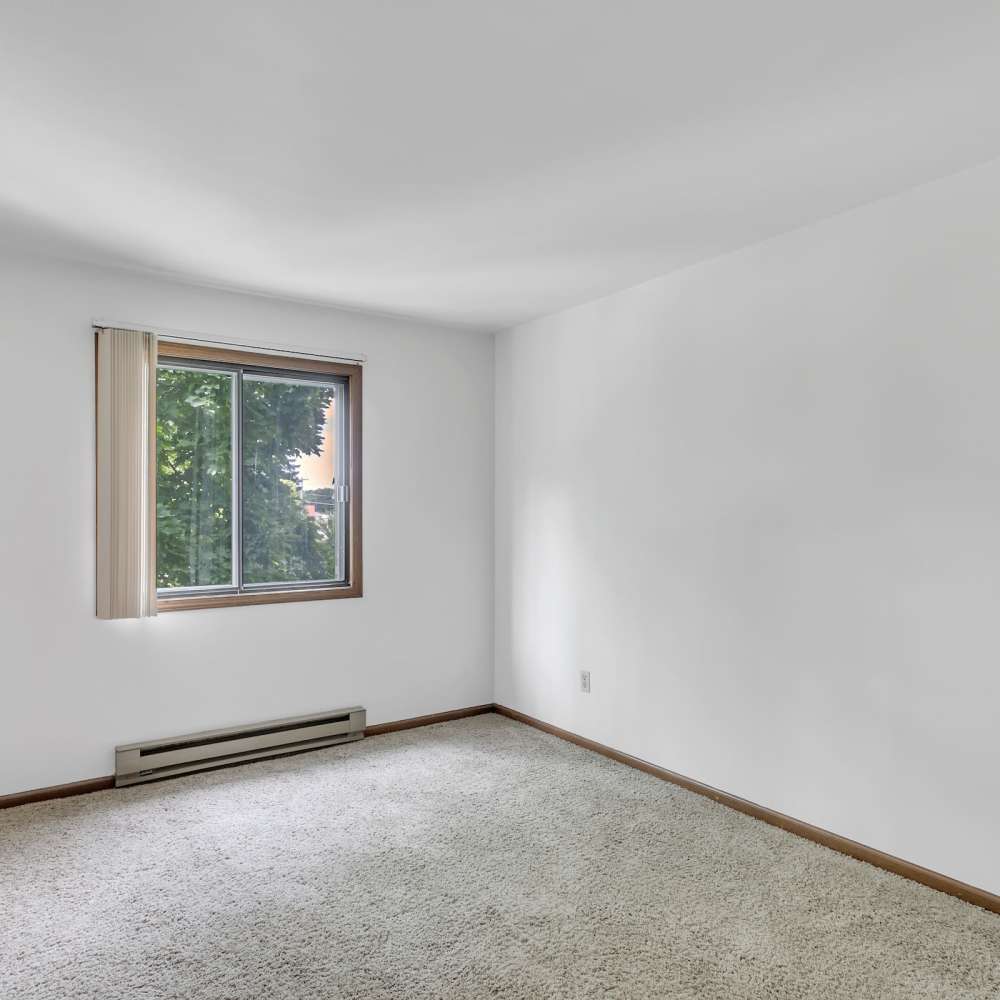 Empty bedroom with plush carpet flooring at Prairie Apartments in Salem,Wisconsin