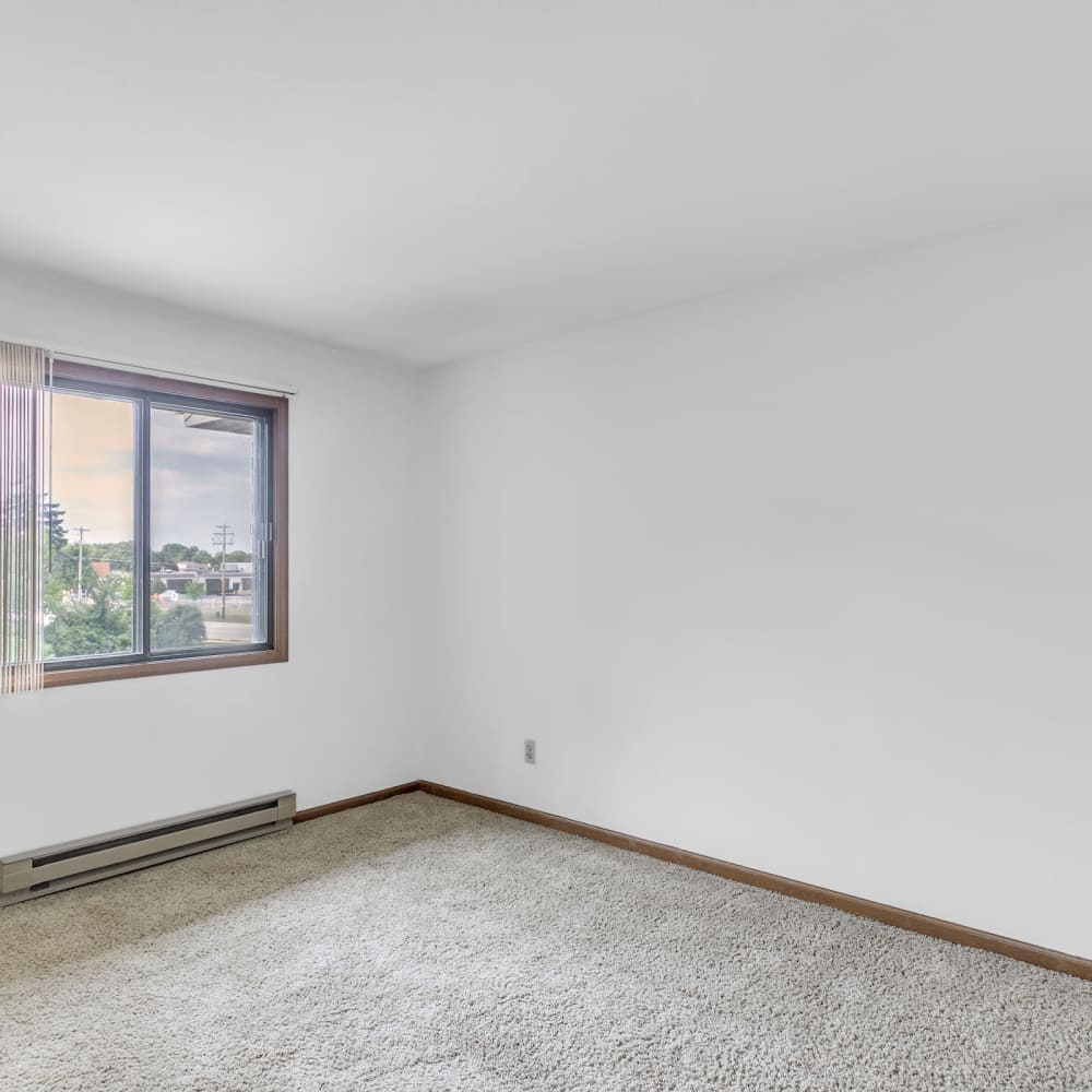 Bedroom with carpet flooring and a window at Prairie Apartments in Salem,Wisconsin