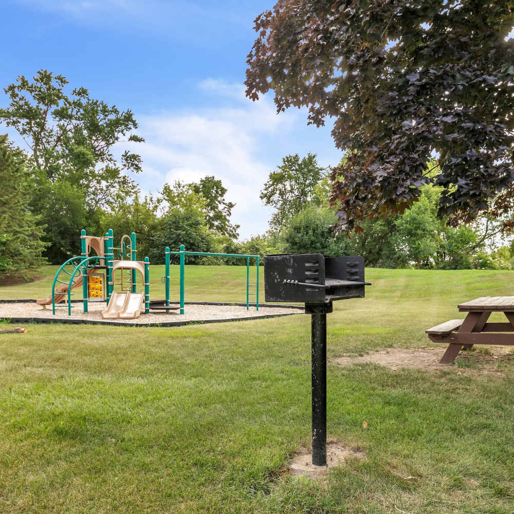 Children play area and wooden benches inside a large community garden at Prairie Apartments in Salem,Wisconsin