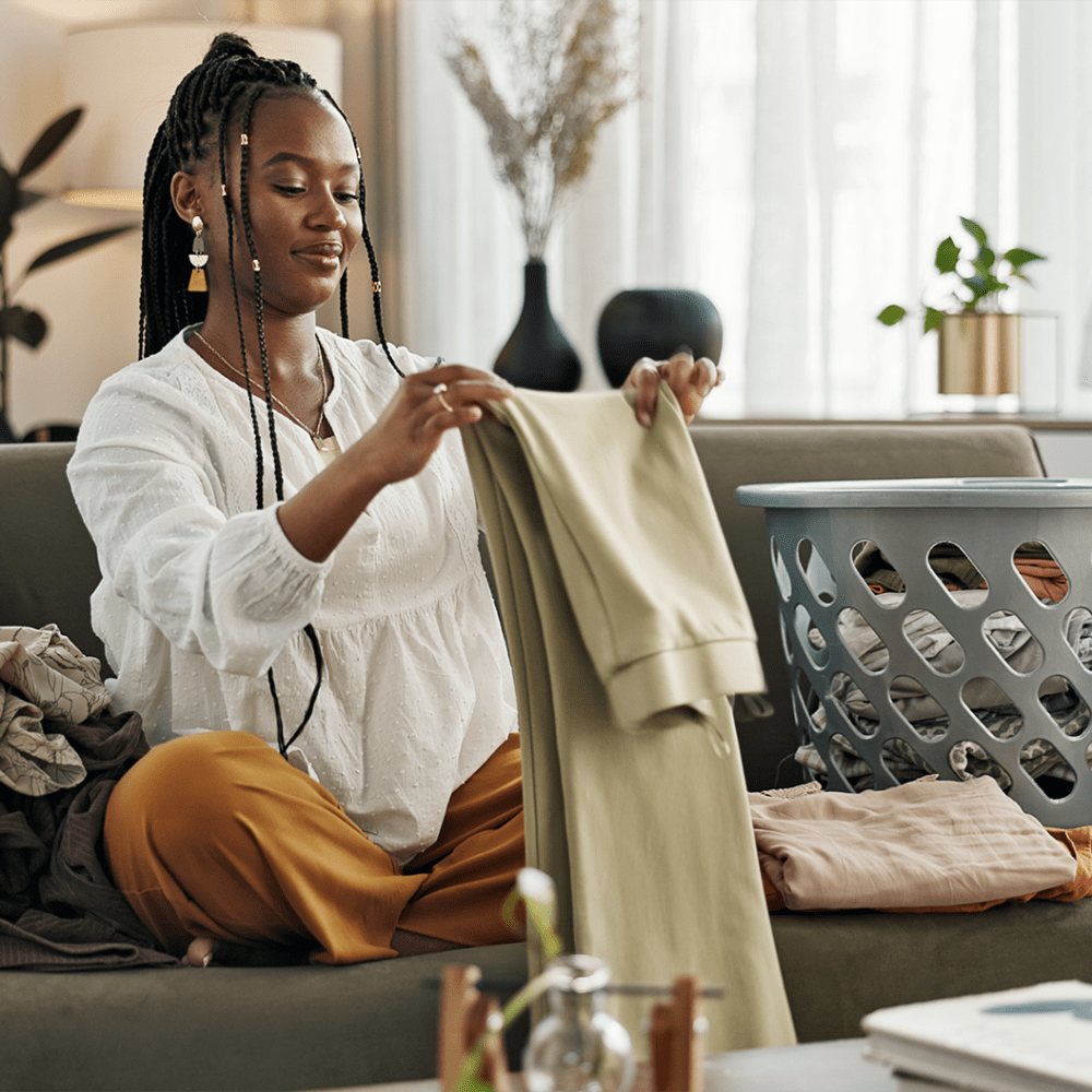 Resident carefully folds her laundry at Elevation @ County Line Station in Englewood, Colorado