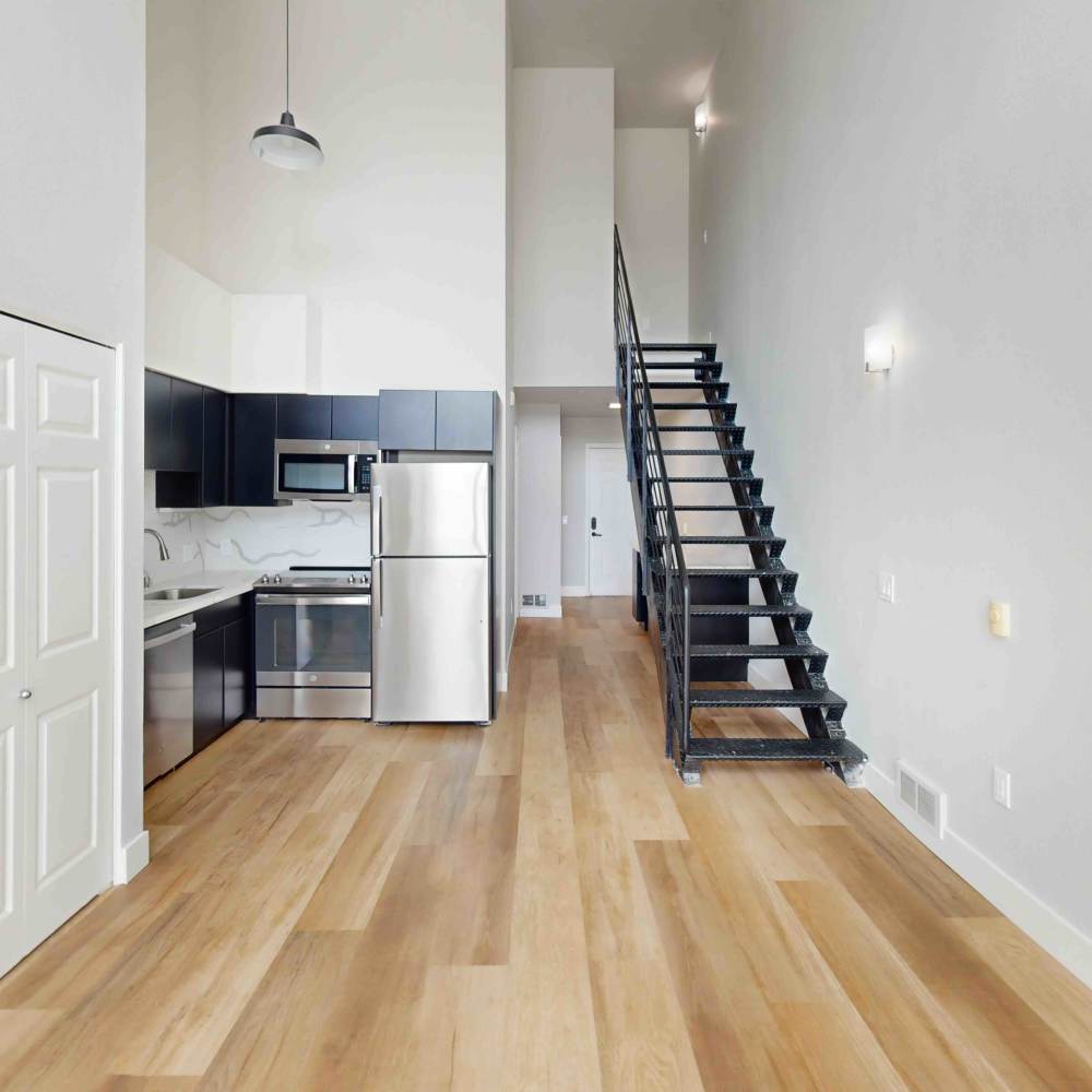 Kitchen showcasing stairs One55 Lofts in San Rafael, California