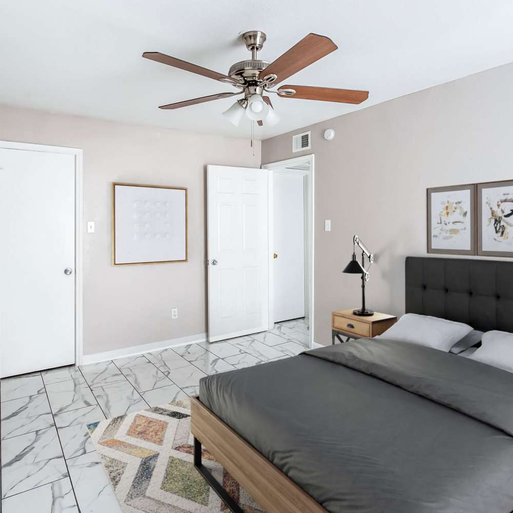 Bedroom with a bed and night stand at The Sanctuary At 9430 in Houston, Texas
