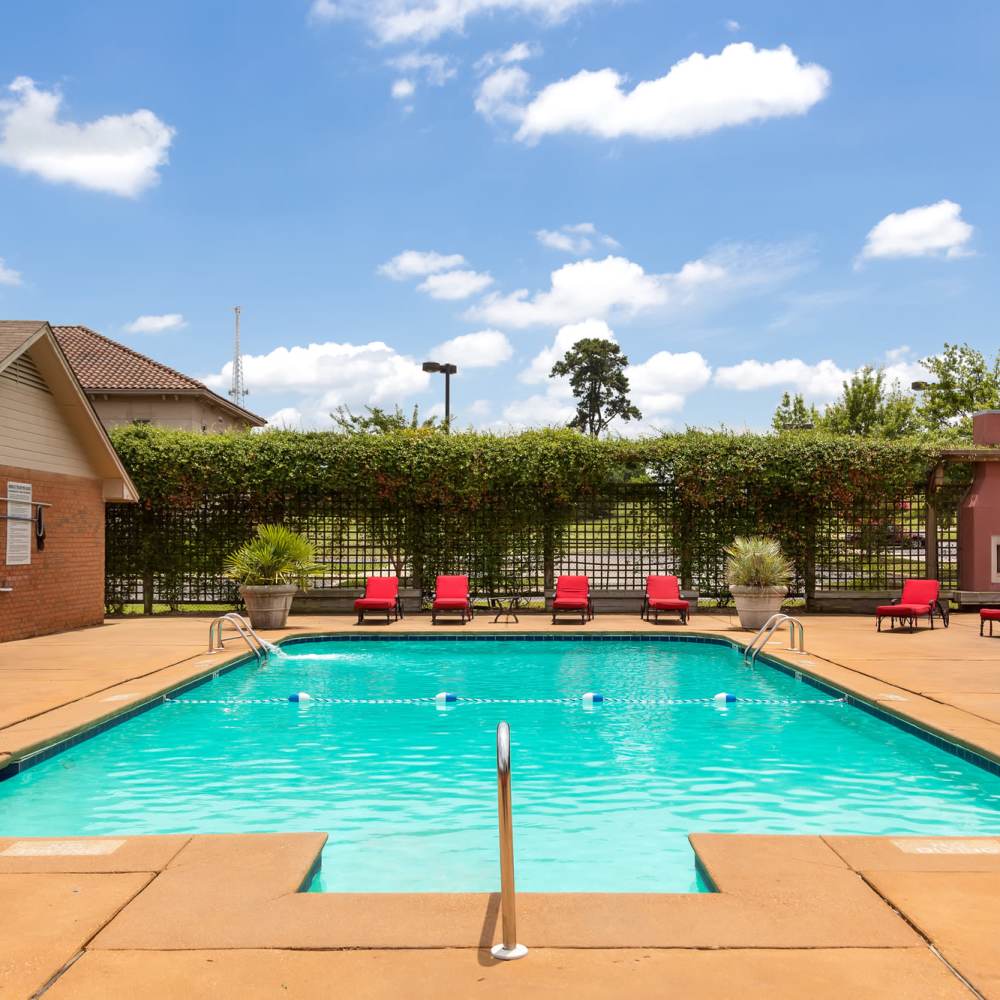 Swimming pool with lounge chairs at The Arbors On Taylor in Montgomery, Alabama