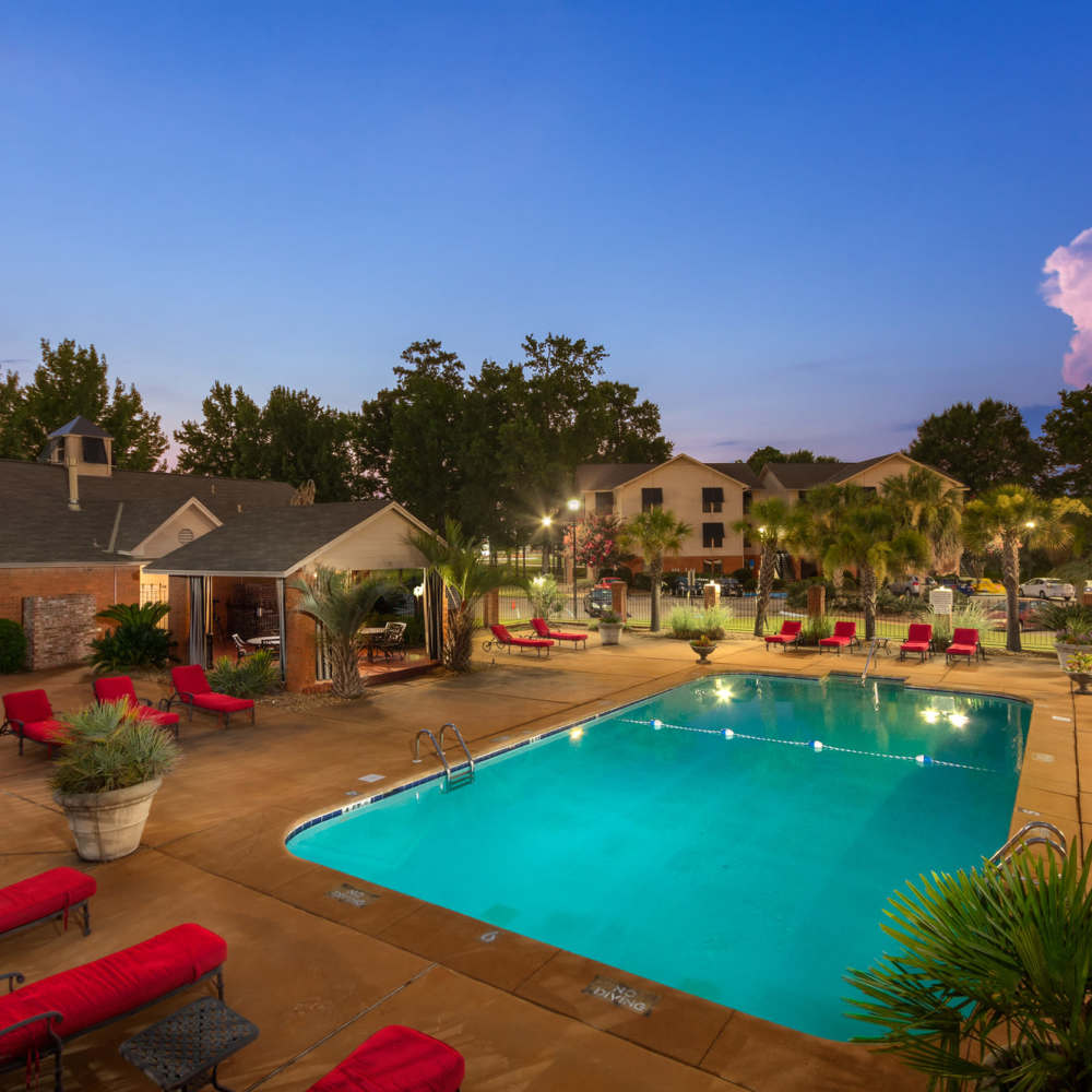 Resort-style swimming pool with multiple lounge chairs at The Arbors On Taylor in Montgomery, Alabama