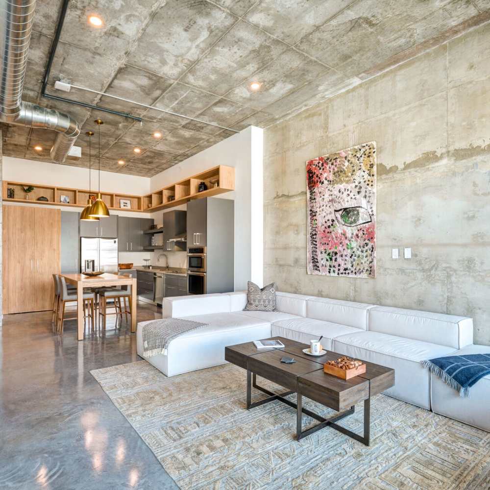 Hardwood-style flooring in the well-furnished living area of an apartment home at The Forge Lofts in Fort Lauderdale, Florida