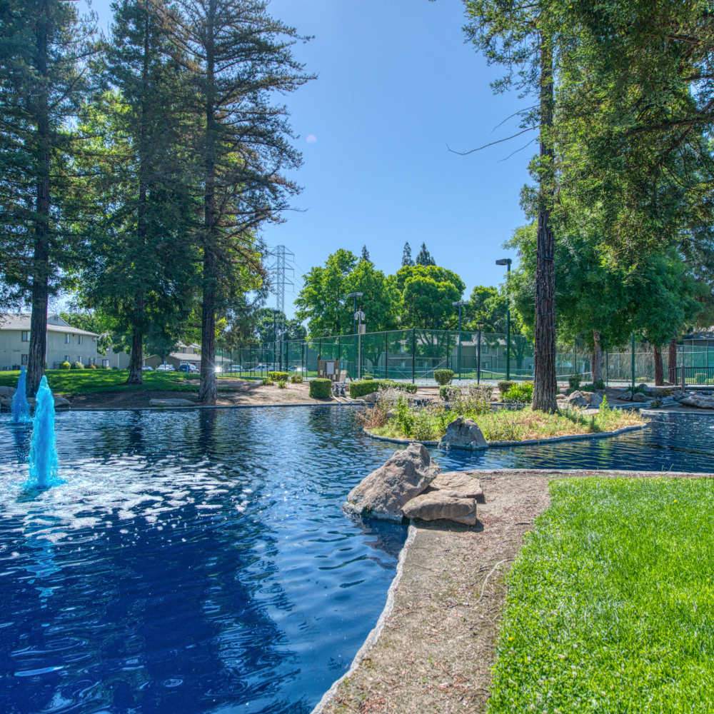 View of beautiful lake grass and walking path at The Landing at Fancher Creek in Fresno, California, 