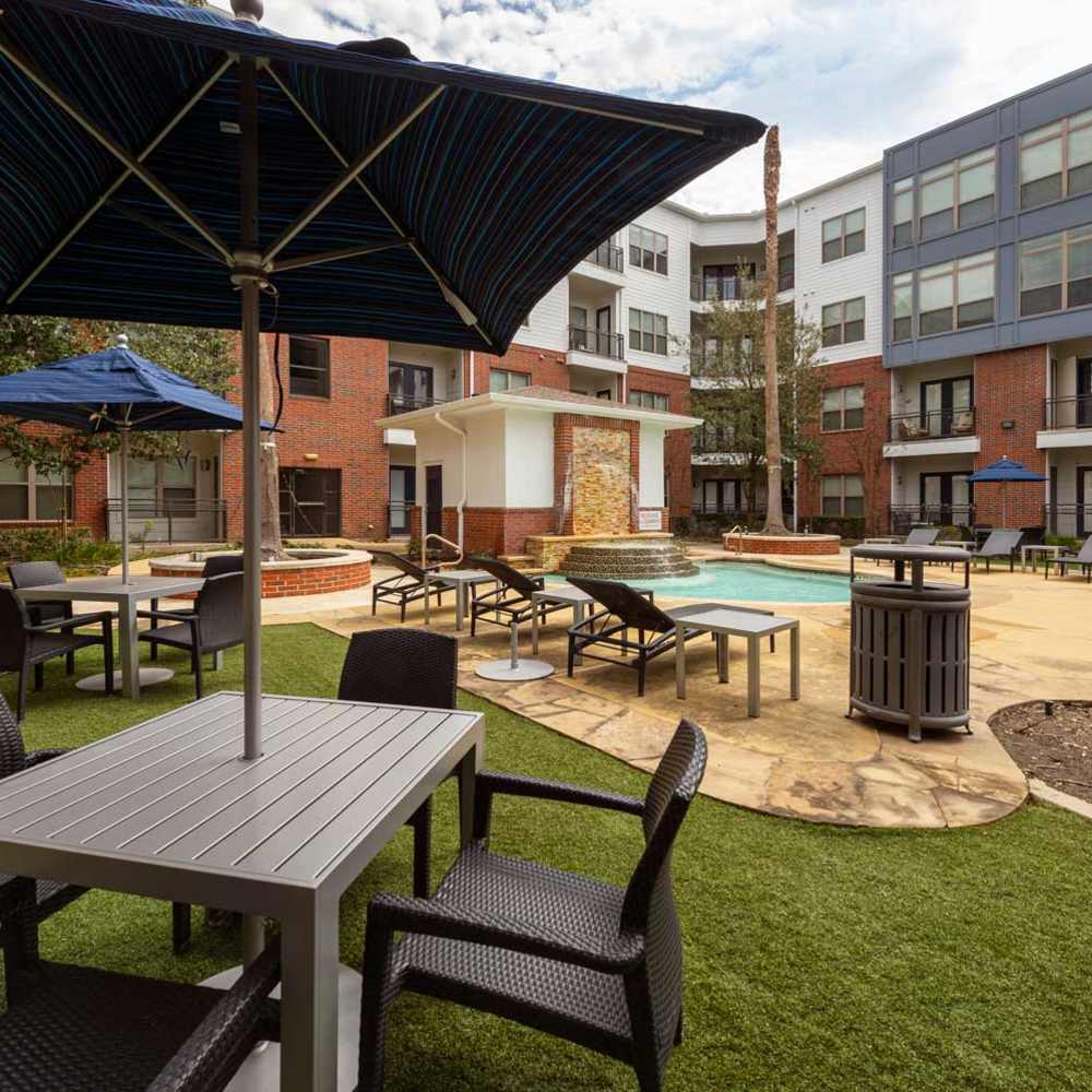 Patio furniture near the pool at The Richmond At Uptown in Houston, Texas