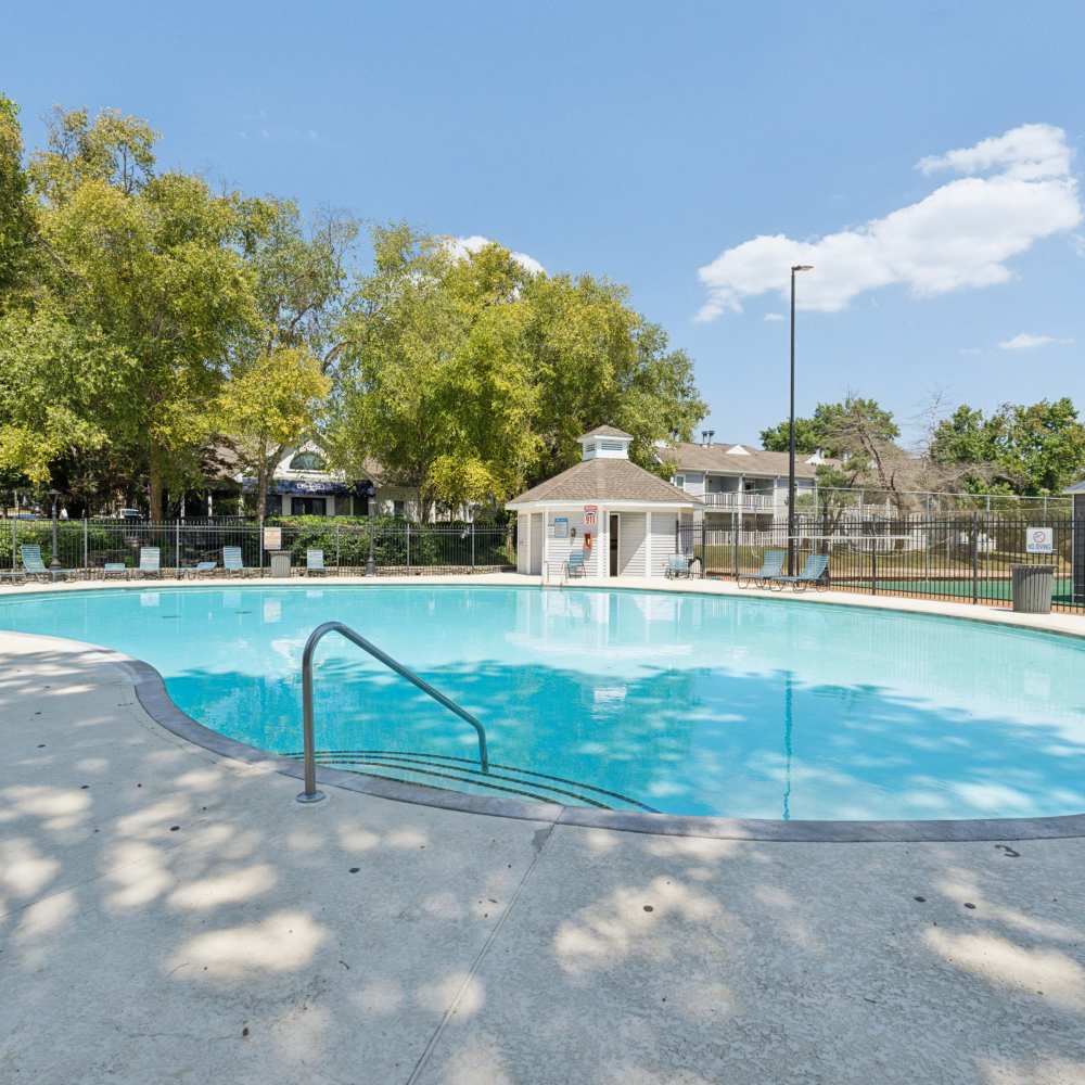 Front entrance view of apartment surrounded by lots of trees at Piccadilly Apartments in Goodlettsville, Tennessee