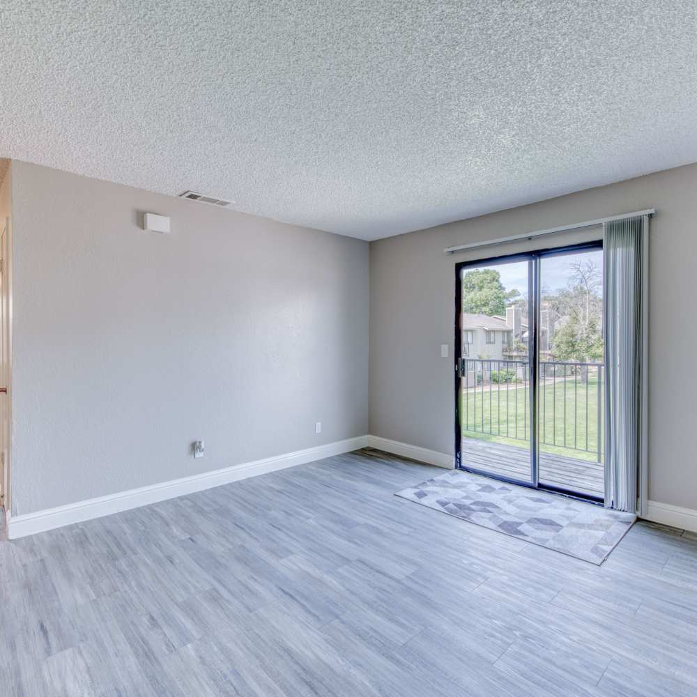 Spacious living room with access to balcony at The Landing at Fancher Creek in Fresno, California, 