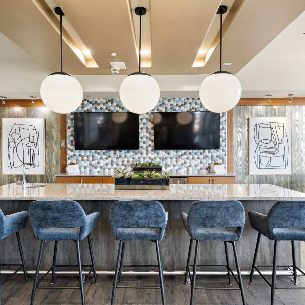 Resident lounge with bar seating at 3800 Main in Houston, Texas
