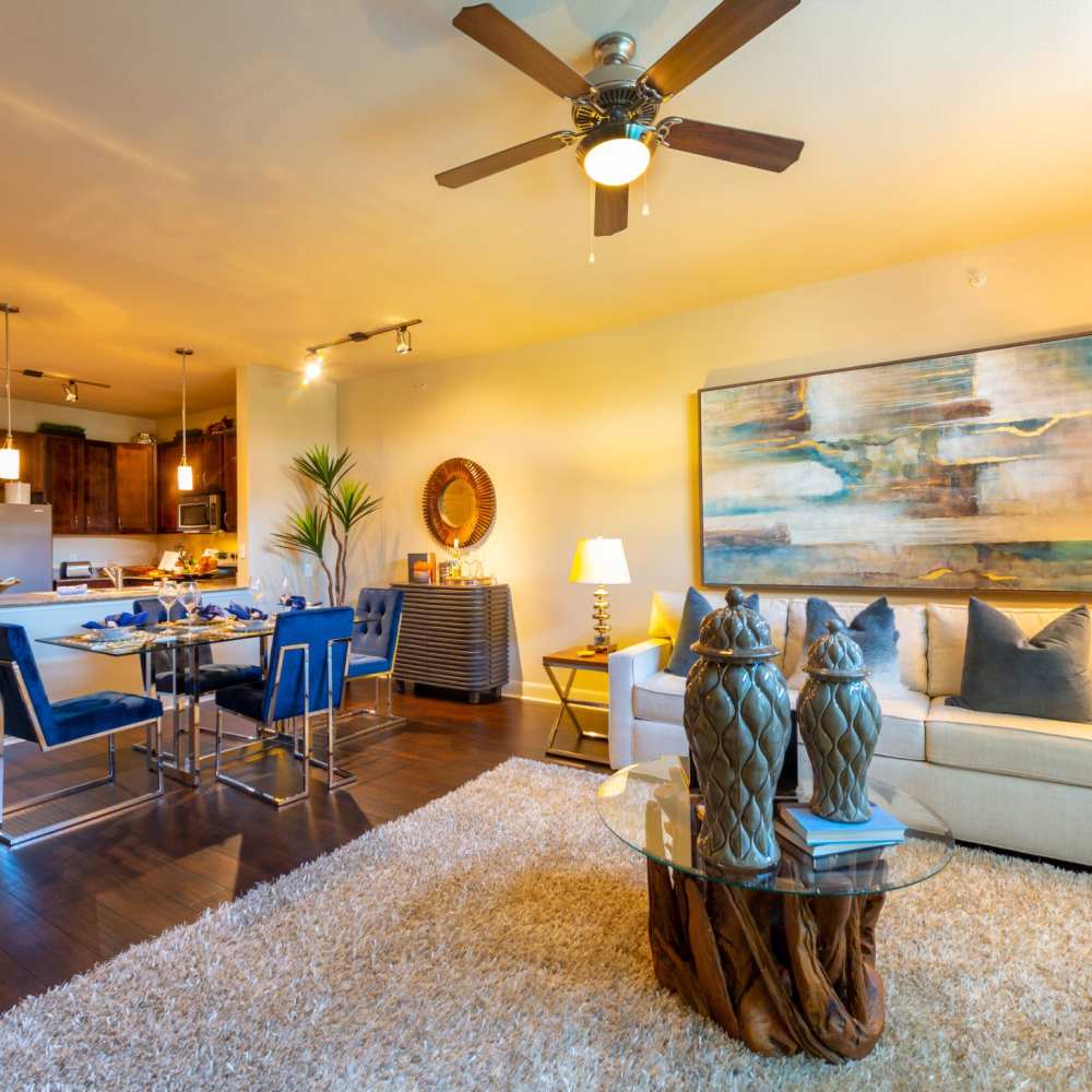 Furnished living room with dining area in apartment at Instrata Upper Kirby in Houston, Texas