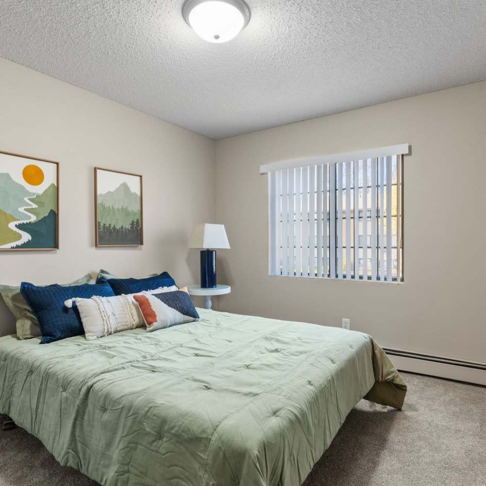 Spacious bedroom with a comfortable bed at Granite Peaks in Minneapolis, Minnesota