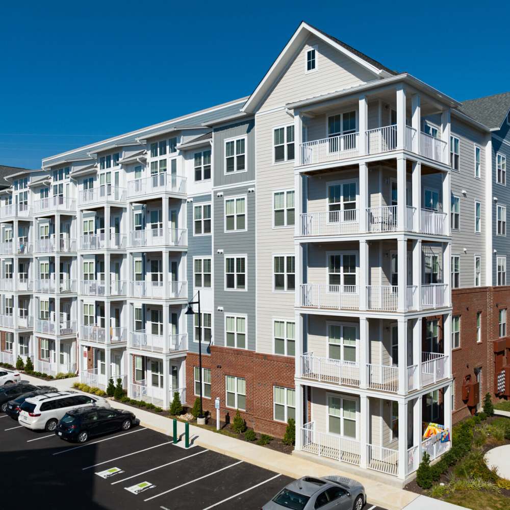 Five-story apartment building with balconies and a parking lot in front at Commonwealth Apartments in Midlothian, Virginia