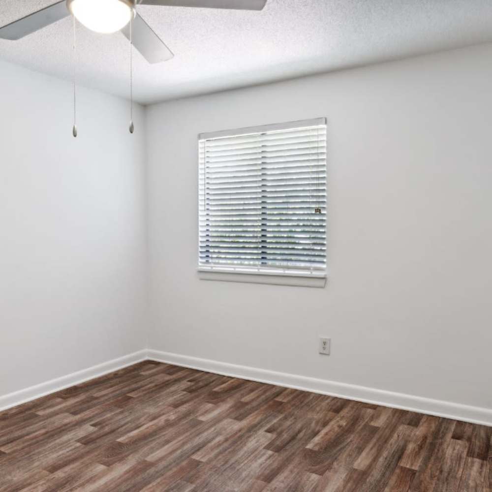 Wood-style flooring and a ceiling fan in a bedroom at The Grove At Hickory Valley in Chattanooga, Tennessee