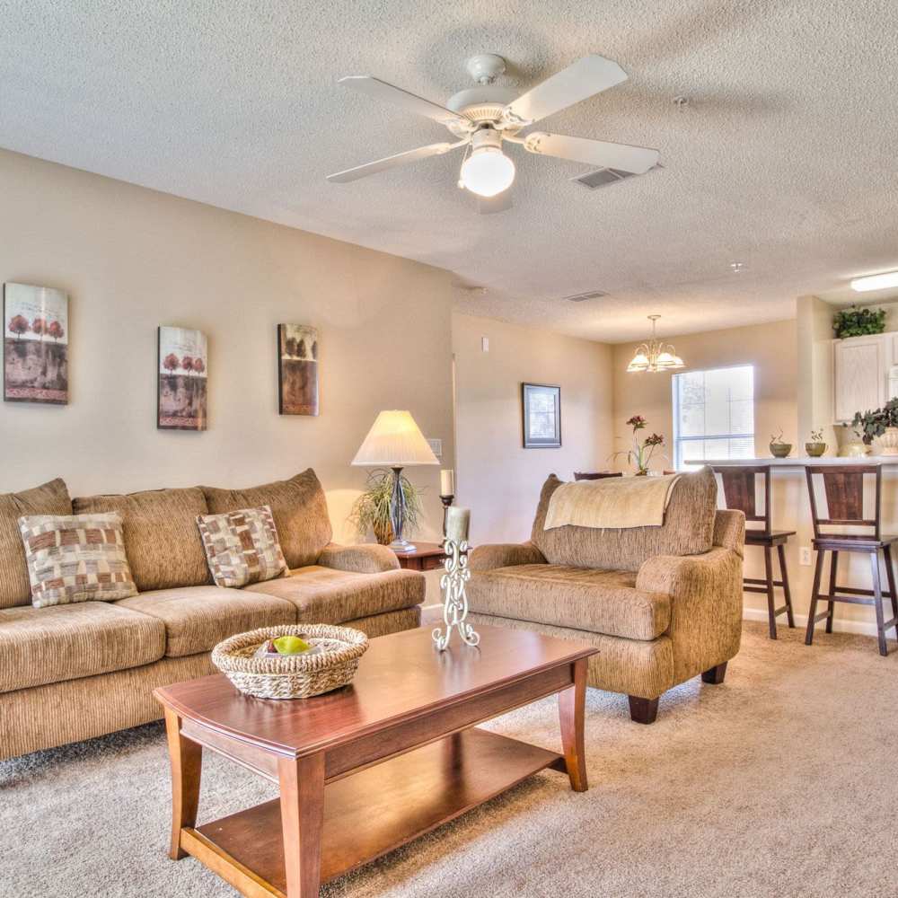 Spacious living room with view of dining room and kitchen at Arbors at the Reservoir in Ridgeland, Mississippi, 