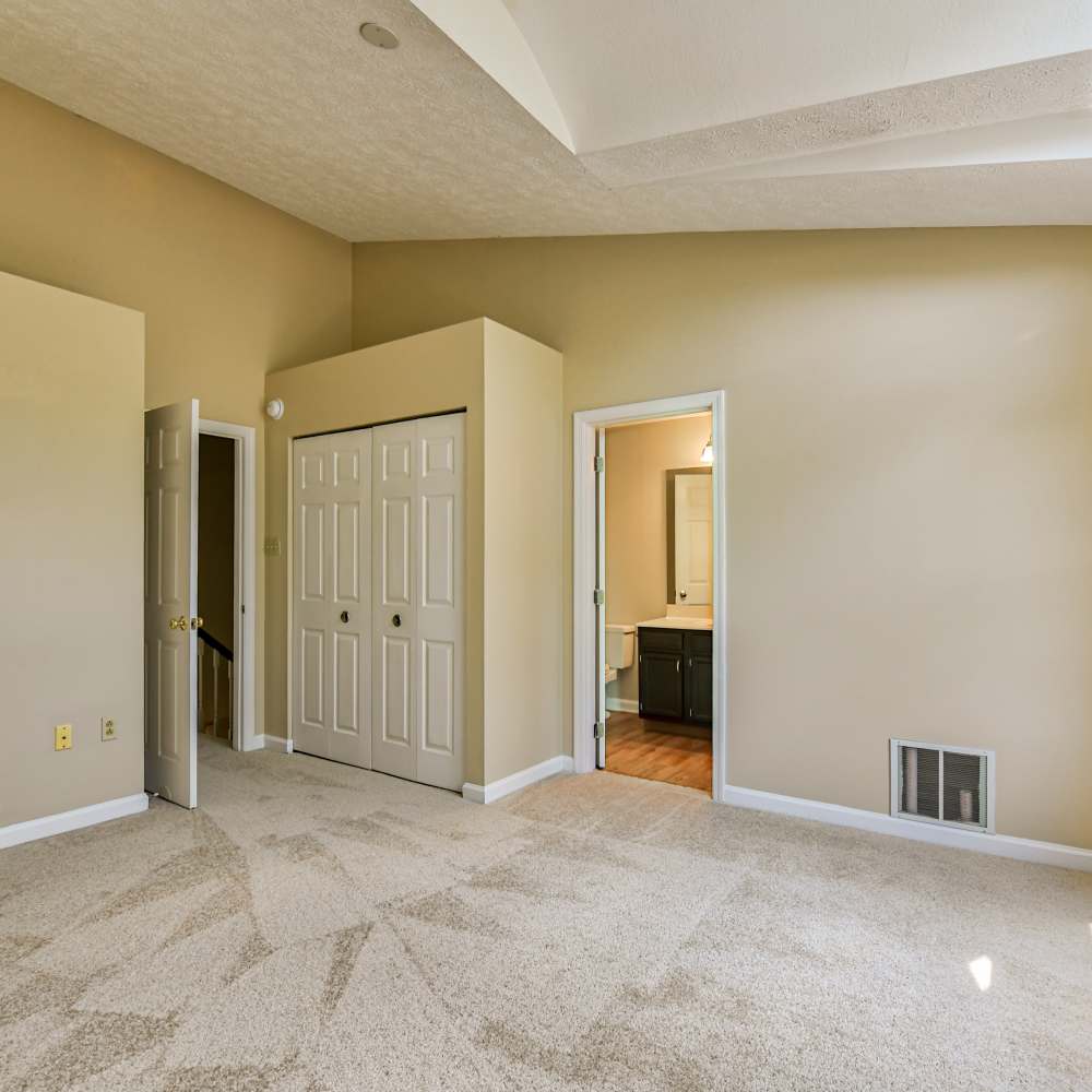 Spacious bedroom with a door leading to the washroom at Hawthorne Estates, Oakdale, Pennsylvania