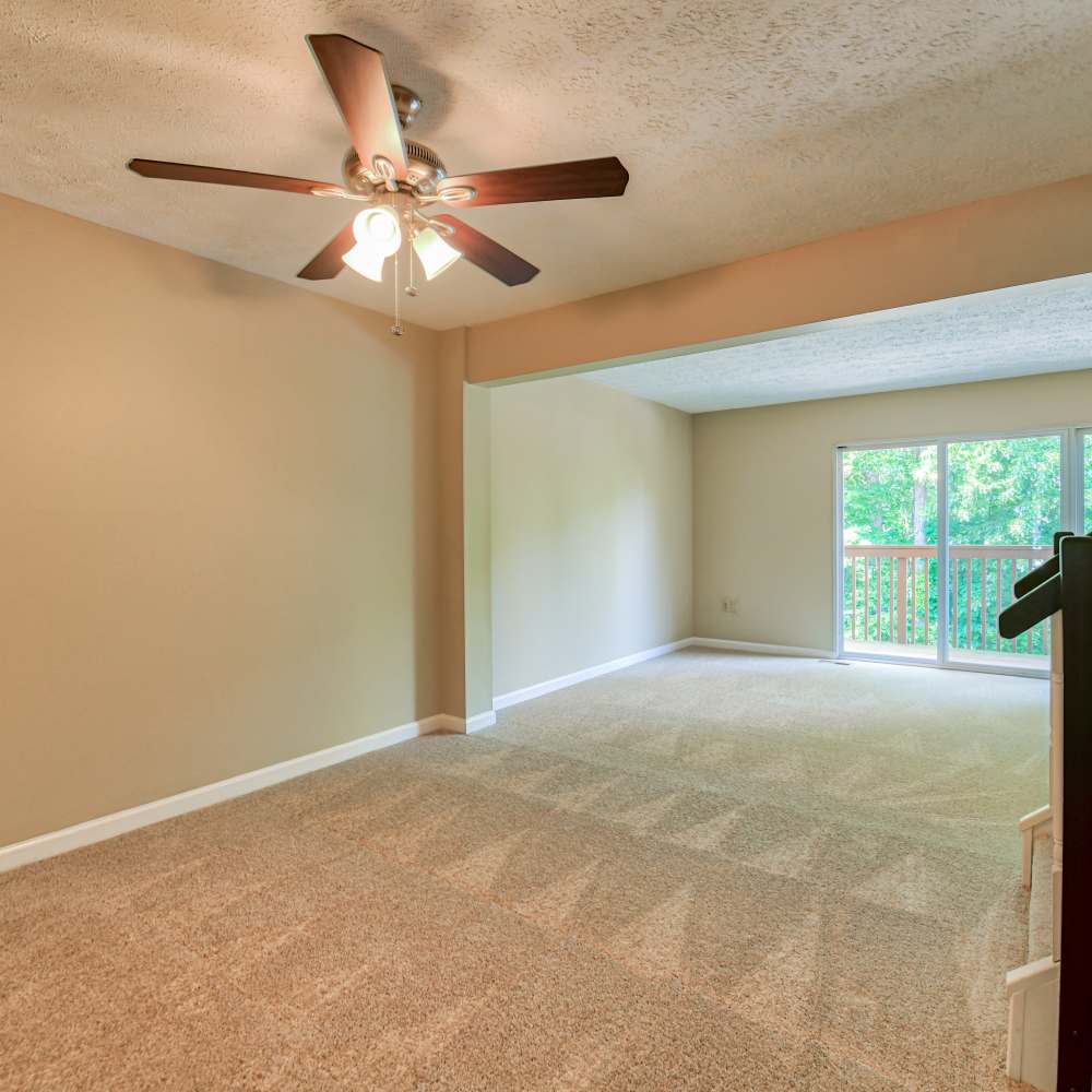 Spacious living room with a sliding door leading to the balcony at Hawthorne Estates, Oakdale, Pennsylvania