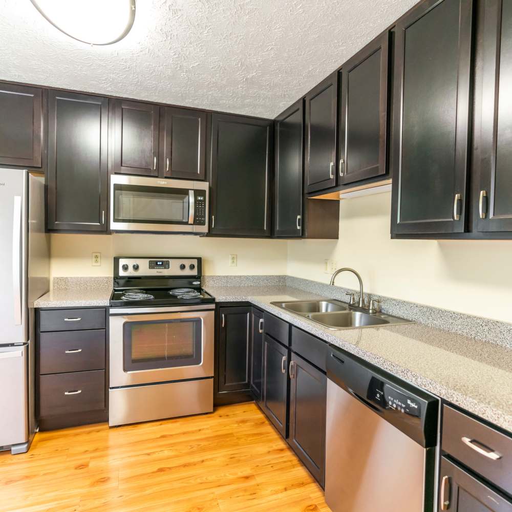 Modern kitchen with wooden cabinets, stainless-steel appliances and granite countertops at Hawthorne Estates, Oakdale, Pennsylvania