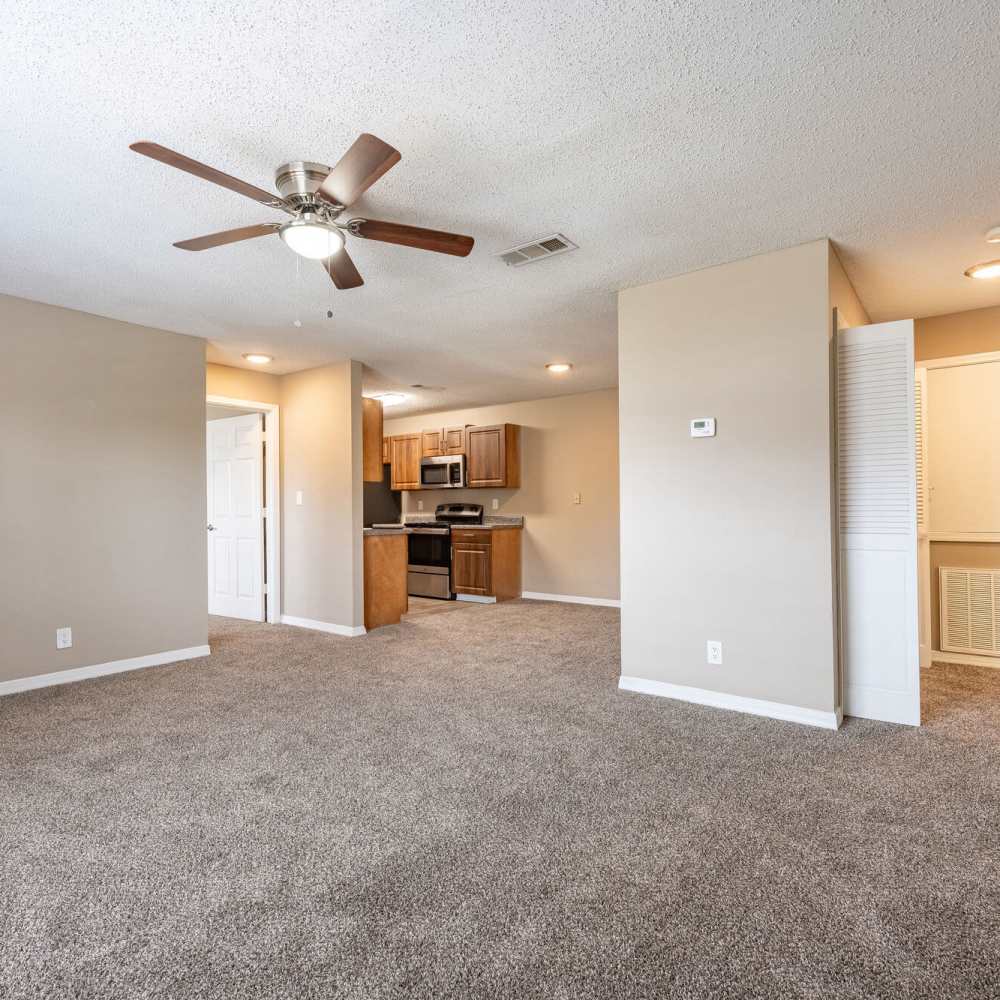 Unfurnished apartment with carpet flooring and a fancy ceiling fan at Royal Gulf Apartments in Biloxi,Mississippi