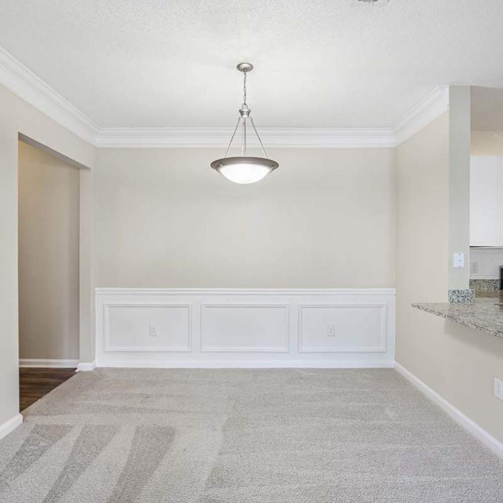 Unfurnished dining room with hanging light at Grande Oaks in Roswell, Georgia 